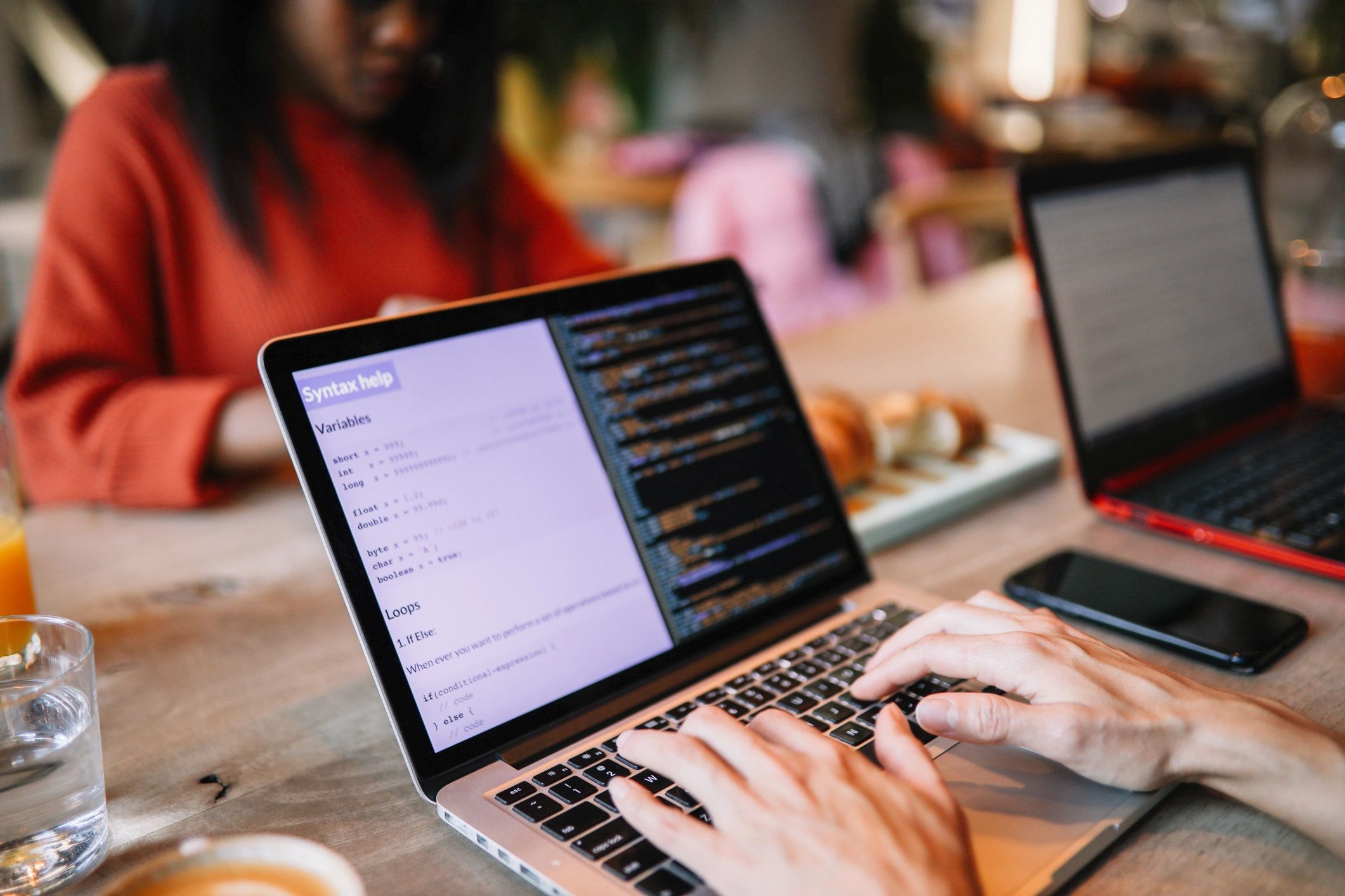 Web developer working on a laptop in a modern workspace