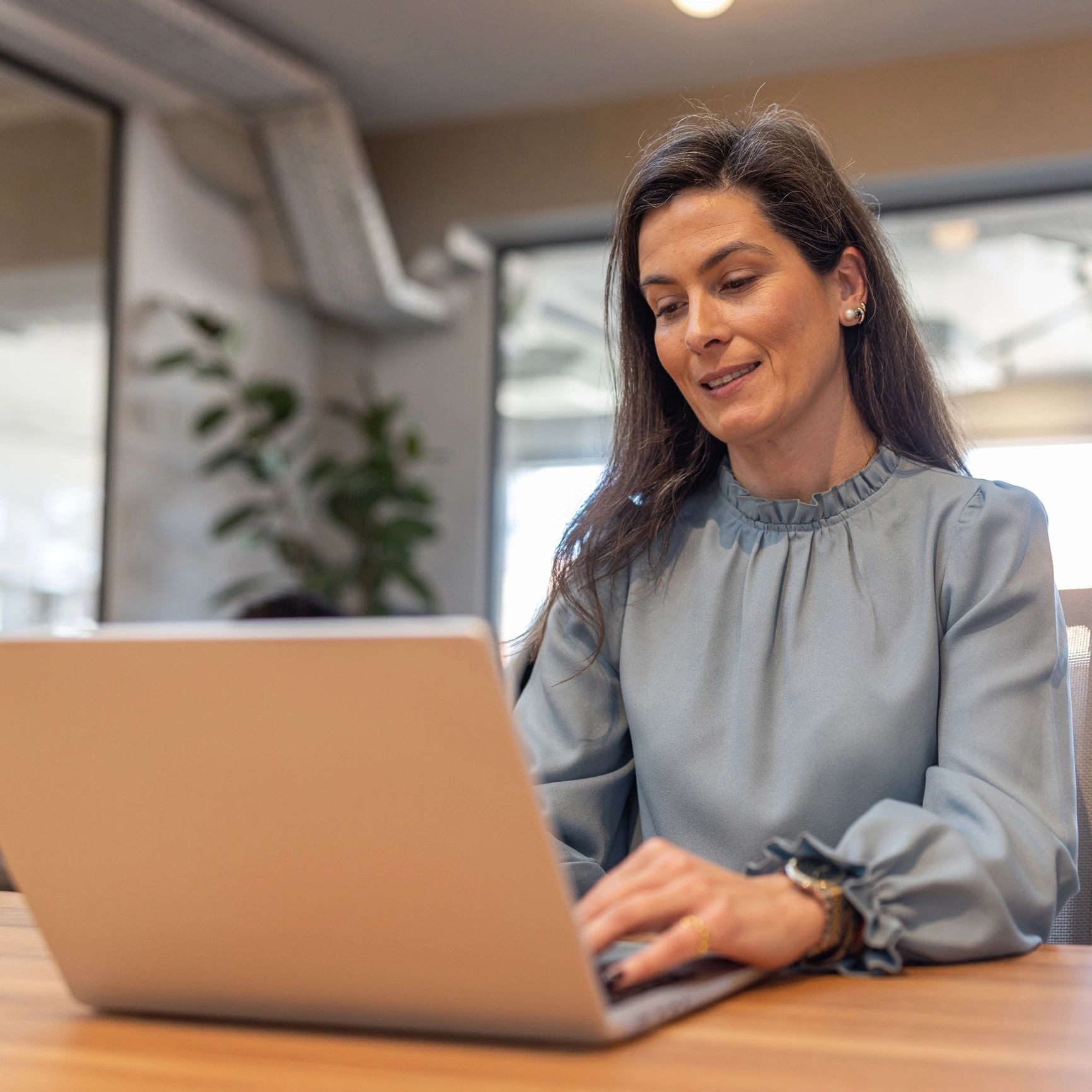 Smiling professional working on a laptop