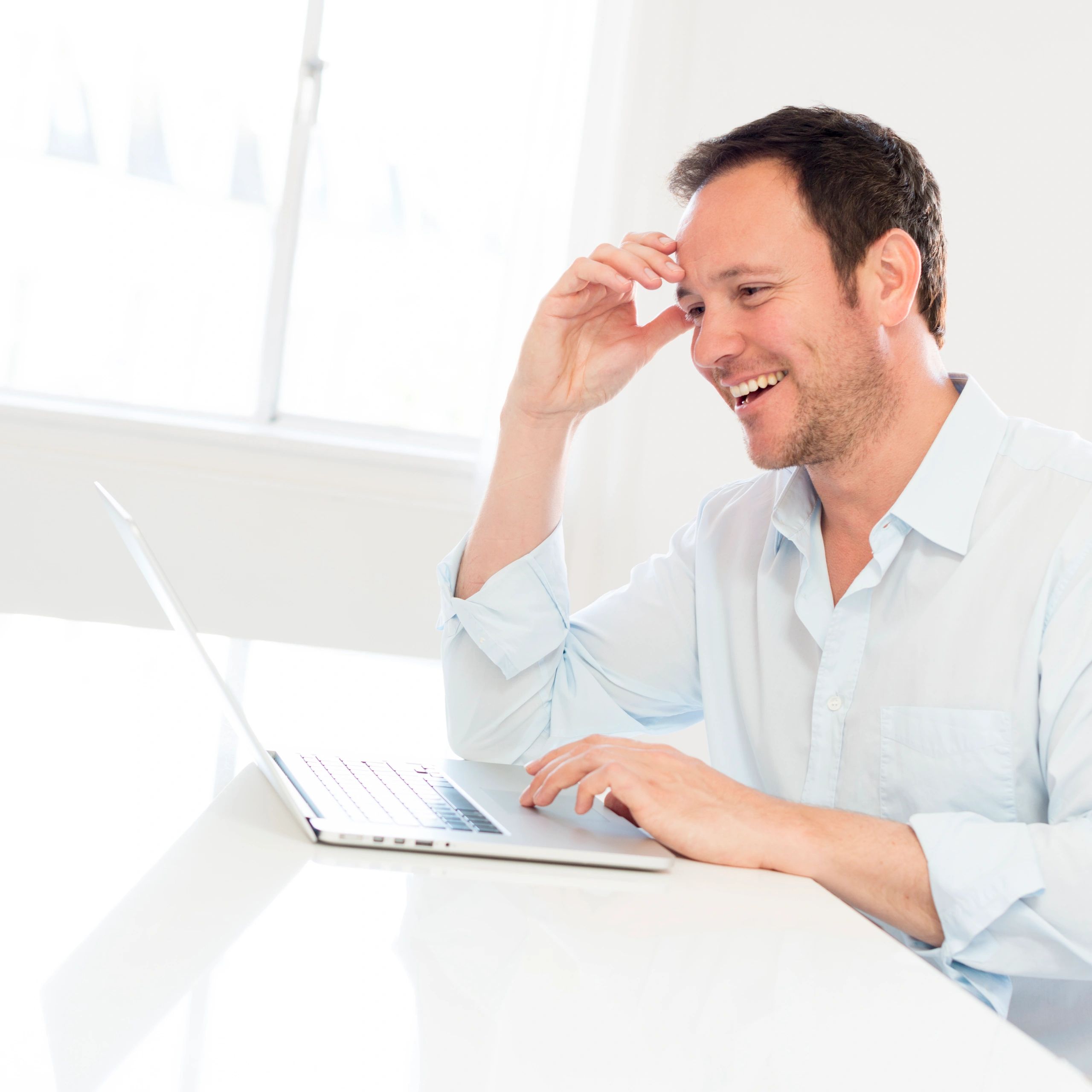Professional using a desktop computer in a bright workspace